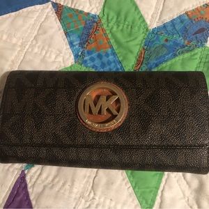 MK wallet brown logo